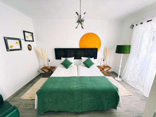 a bedroom with a green and white bed in a room at Casa Solua in Reguengos de Monsaraz