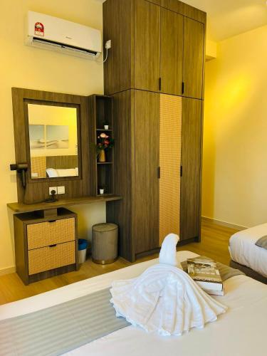 a bedroom with a dress on a bed with a mirror at The Horizon Ipoh By Iconique Espace in Ipoh