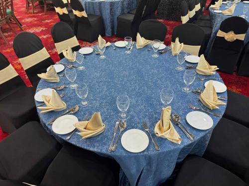 a blue table with glasses and napkins on it at ROYAL PARK HOTEL @ UNITEN in Kajang