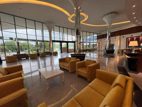 a lobby with couches and tables and a chandelier at ROYAL PARK HOTEL @ UNITEN in Kajang