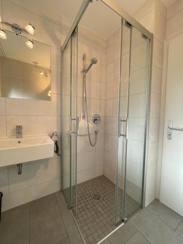 a bathroom with a shower and a sink at Ferienwohnung mit Terrasse und Garten mit Blick auf das Karwendelgebirge in Mittenwald