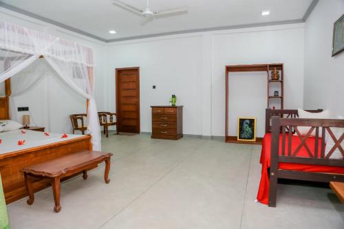 a bedroom with a bed and a desk at Prana Ayurveda Yoga Center in Balapitiya