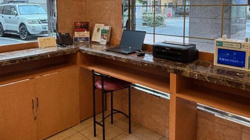 a bar with a desk with a laptop and a printer at Toyoko Inn Soka-eki Nishi-guchi in Soka