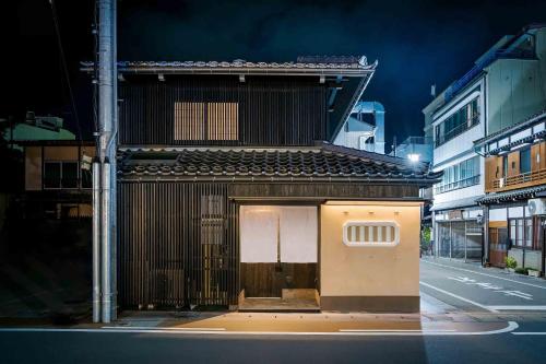 a building with a door on the side of a street at Ichika Machiya House in Takayama