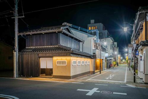 a building on the side of a street at night at Ichika Machiya House in Takayama