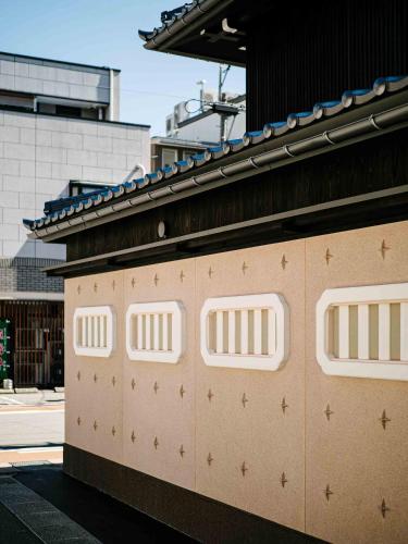 a building with four doors with stars on it at Ichika Machiya House in Takayama