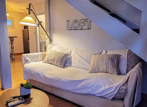 a white couch in a living room with a table at Hotel Hita "Nature Experience" for all in Navacerrada