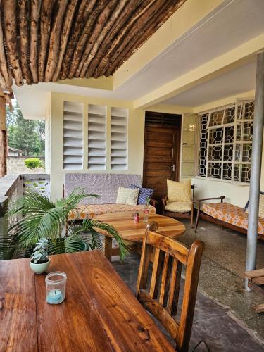 a living room with a table and a couch at Kiwavi Home in Moshi