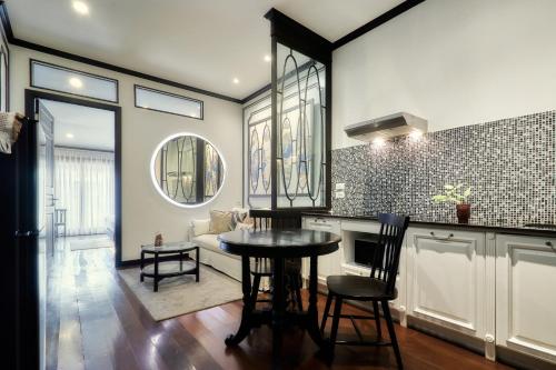 a kitchen with a table and chairs in a room at BAAN 125 STAY Phuket in Phuket Town