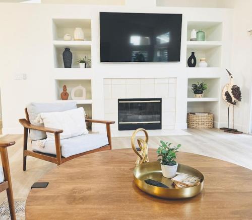 a living room with a tv on the wall at Charming retreat in CA Valley in Fresno