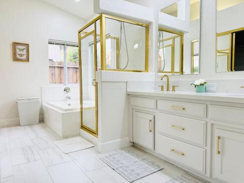 a bathroom with a tub and a sink and a shower at Charming retreat in CA Valley in Fresno
