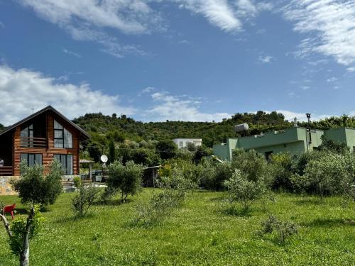a house in the middle of a field of grass at Villa Kei in Tirana