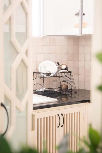 a kitchen counter with a toaster on a drying rack at CASA SIRA-Charming home in the heart of the Kasbah in Tangier