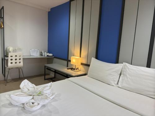 Regent Ngamwongwan Hotelにあるベッド