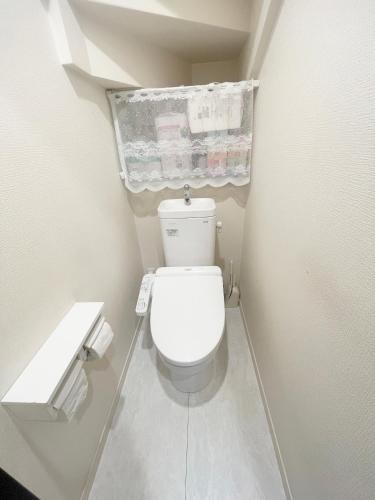a small bathroom with a white toilet in a room at 花乃郷 北小岩 in Tokyo