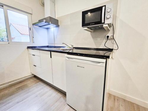 a small kitchen with a sink and a microwave at Complejo Bubal Formigal 3000 in Búbal