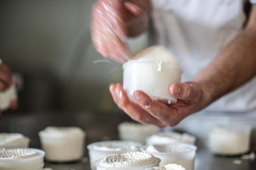 a man is holding a cup of marshmallows at Agriturismo Why Farm in Marano Ticino