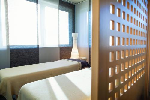 a room with two beds and a window at Hotel Abácie & Wellness in Valašské Meziříčí