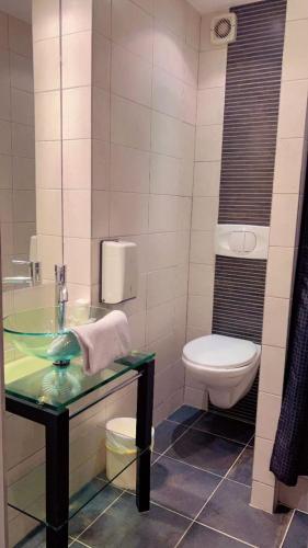 a bathroom with a sink and a toilet at Hôtel Du Midi in Narbonne