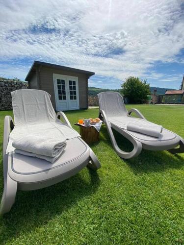 two chairs sitting on the grass in a yard at Domus MEA - Breakfast Included! in San Martino Buon Albergo