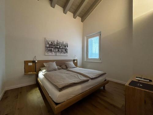 a bedroom with a large bed in a room at Domus MEA - Breakfast Included! in San Martino Buon Albergo