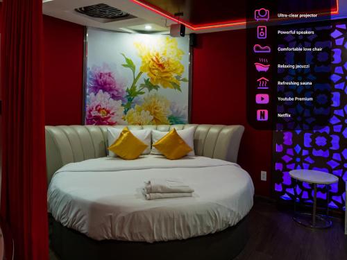a bedroom with a white bed with yellow pillows at Cupid Hotel in Ho Chi Minh City