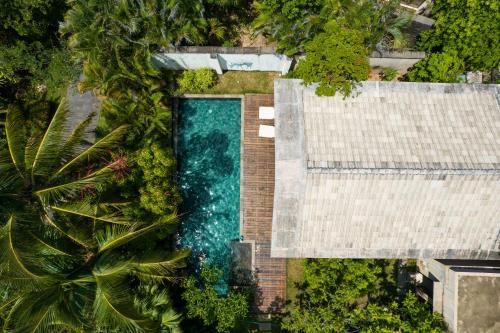 an overhead view of a swimming pool next to a house at Narada Resort & Spa Perfume Bay Sanya - All Villas in Lingshui