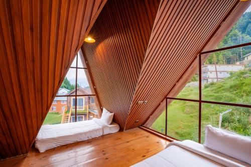 a room with two beds and a large window at WOW STAYZ2 Ashoka Grand in Dalhousie