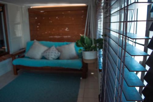 a blue couch in a room with a staircase at The Salty Surf Shack in Cape Town