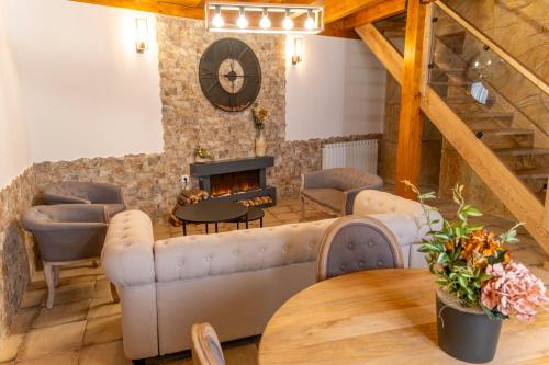 a living room with a couch and a fireplace at Hotel Rural La Bodega del Baldomero in San Esteban de Gormaz