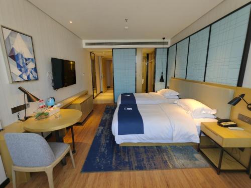 Katil atau katil-katil dalam bilik di Echarm Hotel Dongxing Minzu Road