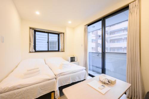 Postel nebo postele na pokoji v ubytování Oku Apartment