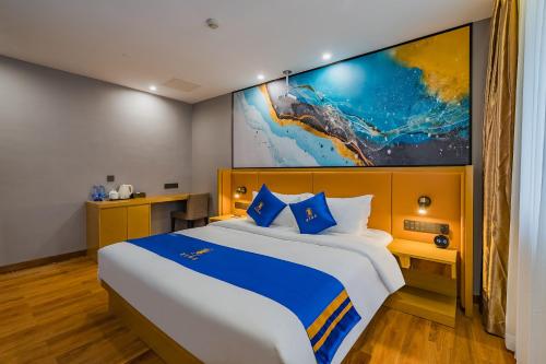 a bedroom with a large bed with a large painting on the wall at Super 8 Hotel Select Guangzhou Station Xicun Metro Station in Guangzhou