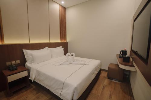 Postel nebo postele na pokoji v ubytování Parkside's Hotel Palembang