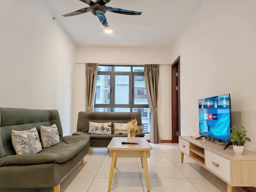 a living room with a couch and a tv at K Avenue Kota Kinabalu in Donggongon