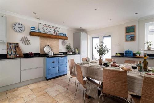 a kitchen and dining room with a table and chairs at Quay House Luxury Living for 10 & Private Parking in Topsham