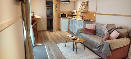 un petit salon avec un canapé et une table dans l'établissement BERCK-PLAGE - 4 Hébergements insolites Tiny House de 2 à 18 personnes, à Berck-sur-Mer