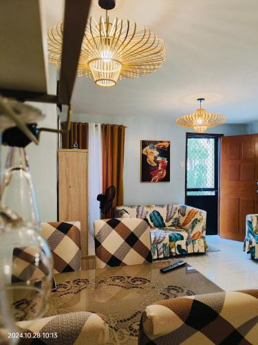 a living room with couches and a glass table at Asuncion Staycation and House rental in San Pablo