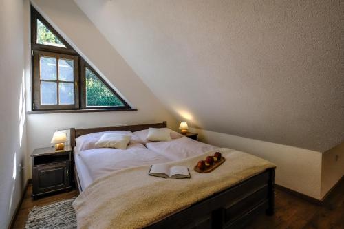 a bedroom with a bed with two shoes on it at Stará Zvonica in Nižná Boca