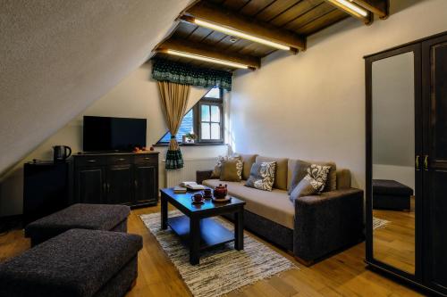 a living room with a couch and a table at Stará Zvonica in Nižná Boca