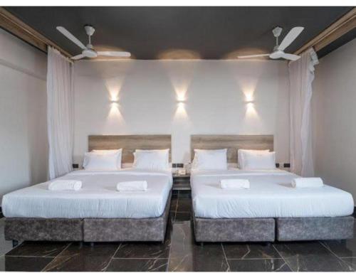 Ένα ή περισσότερα κρεβάτια σε δωμάτιο στο The Ivory Suites
