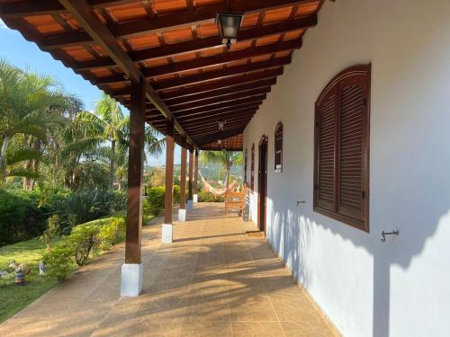 a porch of a house with a wooden pergola at Casa de Campo com Piscina in Itupeva
