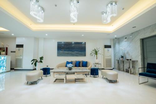 a living room with a couch and a table and chairs at Stacia Hotel in Cebu City