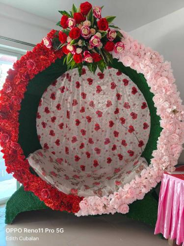a large cake with red roses on top of it at ECB Guest House in Siquijor