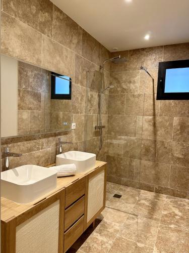 une salle de bain avec deux lavabos et une douche dans l'établissement Villa du Canon, à Lège-Cap-Ferret