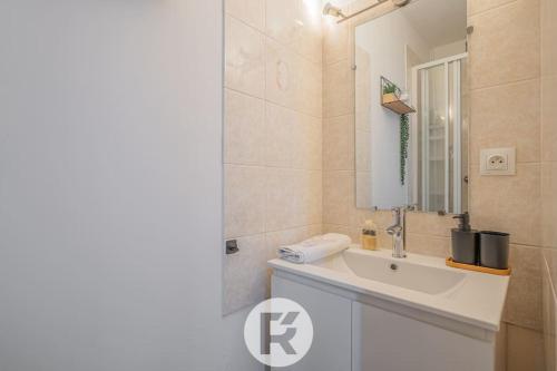 une salle de bain avec un lavabo et un miroir dans l'établissement R'Apparts T2 Cocon des Alpes, Climatisation, à Grenoble