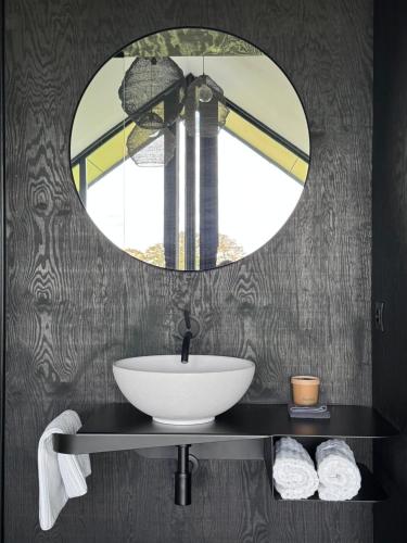 a bathroom with a sink and a mirror at Durbuy Insolite - Panoramic Escape in Durbuy