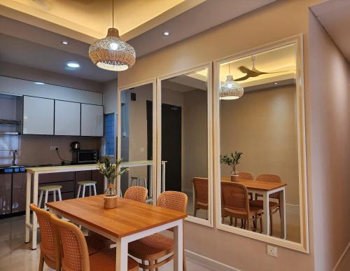 a kitchen and dining room with a table and chairs at UKM Bangi Wonderland 3BR 2bath 2parking in Kampong Tangkas