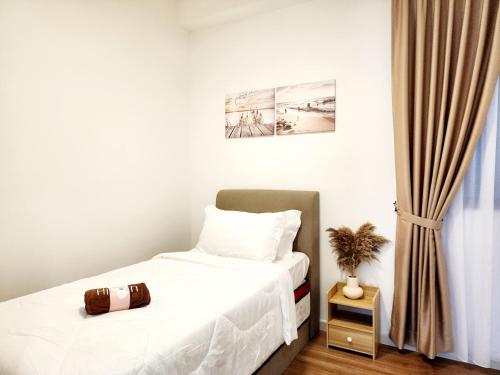 a bedroom with a bed with white sheets at UKM Bangi Wonderland 3BR 2bath 2parking in Kampong Tangkas