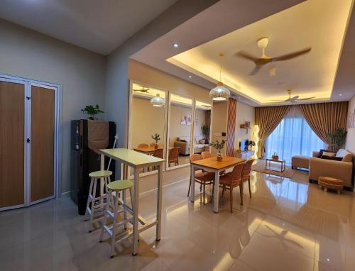 a kitchen and living room with a table and chairs at UKM Bangi Wonderland 3BR 2bath 2parking in Kampong Tangkas